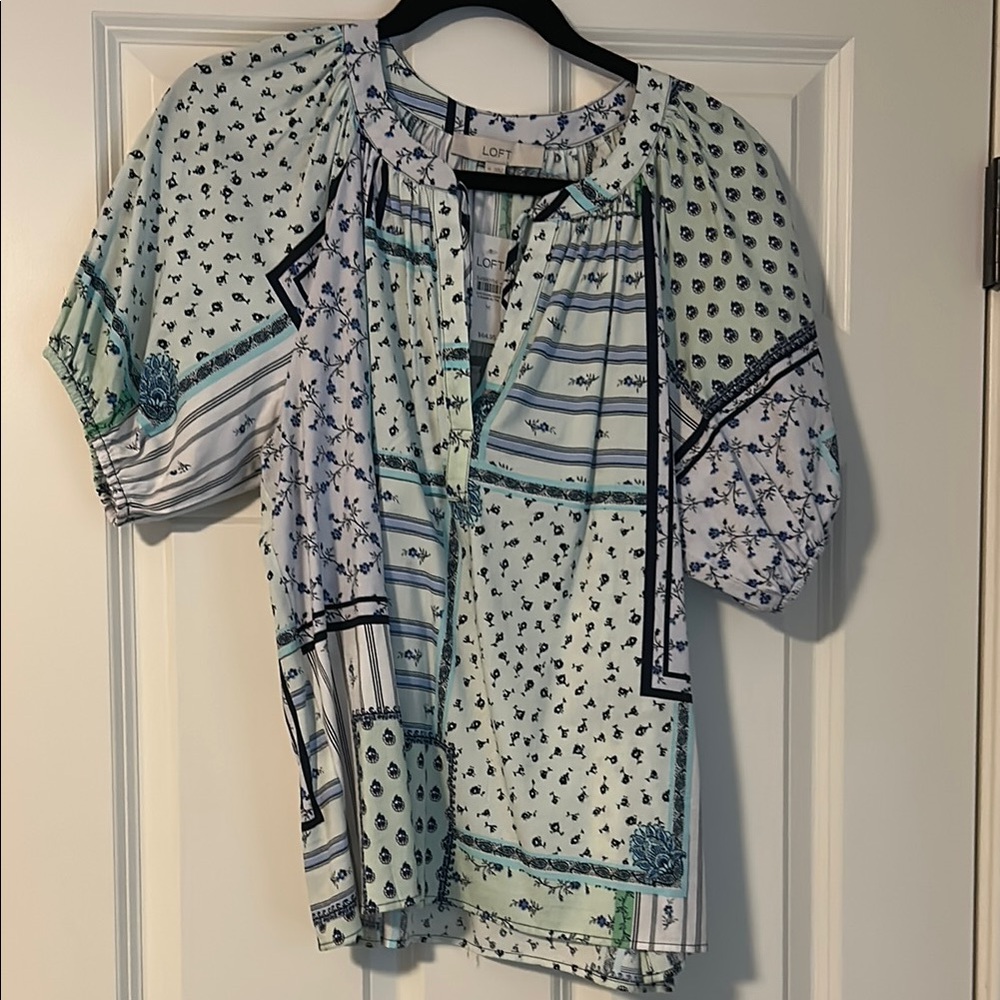 Women’s summer weight top. Size medium new with tags.